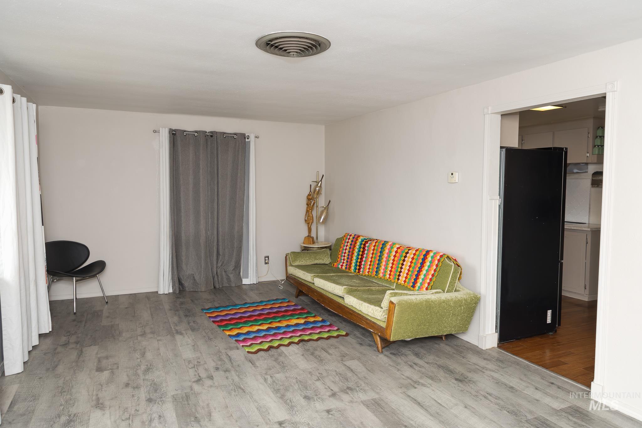 661 Southwest 3rd Street Ontario, OR 97914 - Photo 3 of 45 Living area with light wood-style floors and baseboards