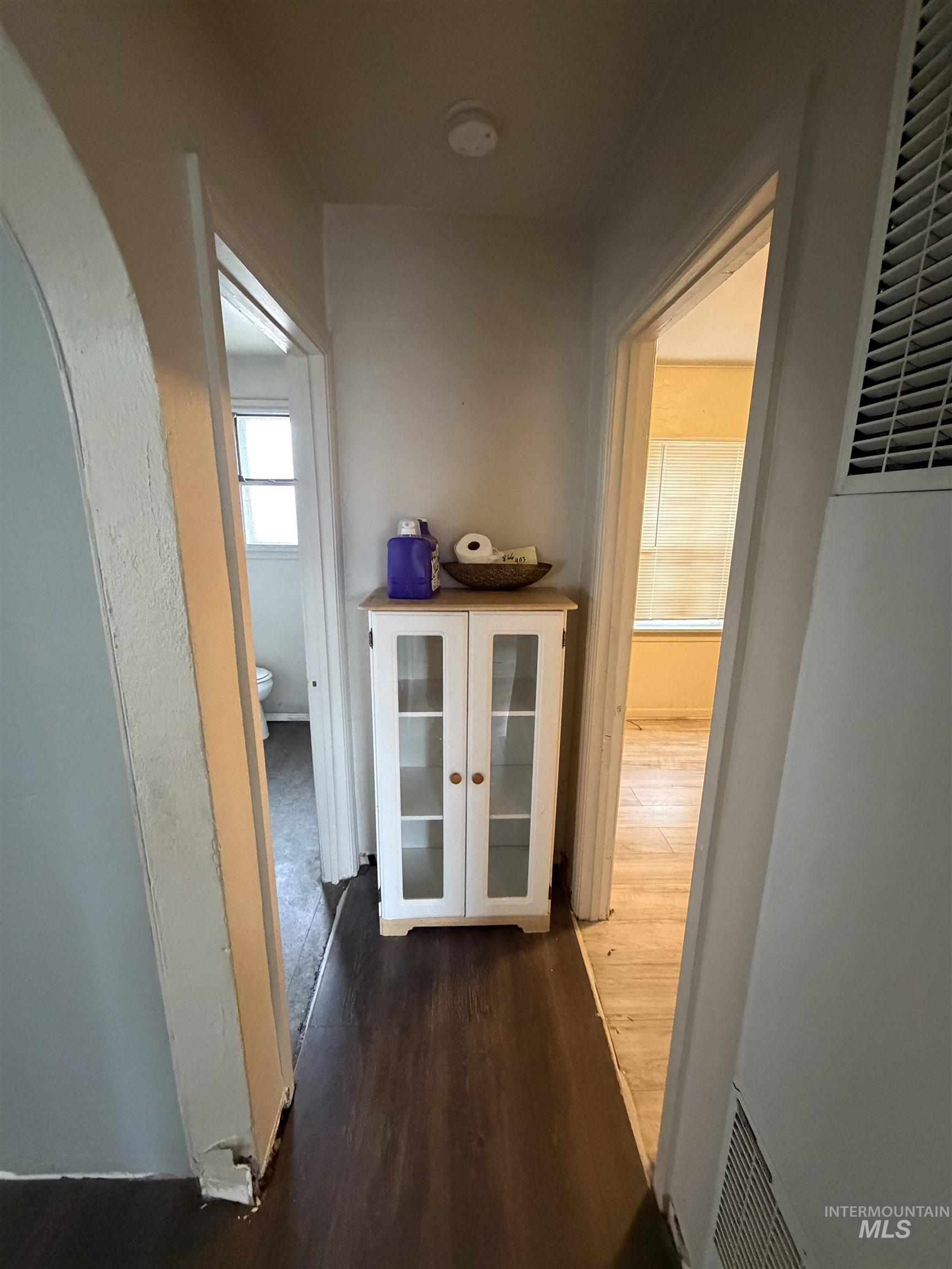 661 Southwest 3rd Street Ontario, OR 97914 - Photo 41 of 45 Hallway featuring dark wood finished floors, a heating unit, and arched walkways