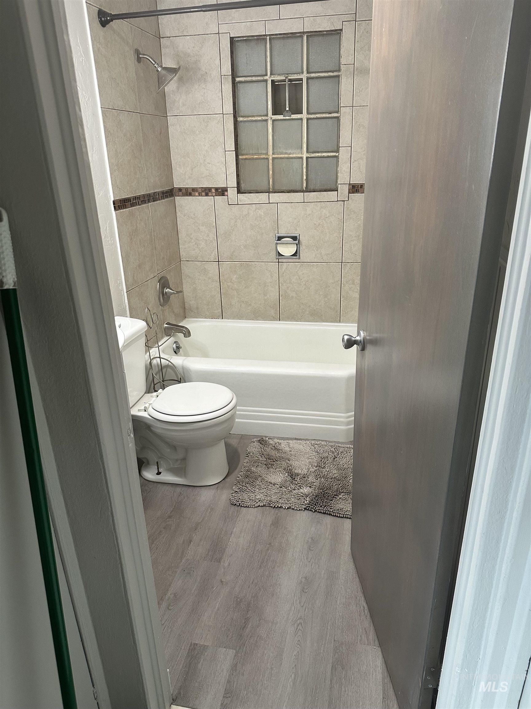 661 Southwest 3rd Street Ontario, OR 97914 - Photo 10 of 45 Full bathroom featuring light wood-type flooring and shower combination
