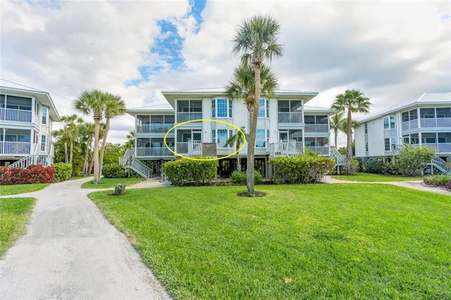 a front view of a house with garden and plants