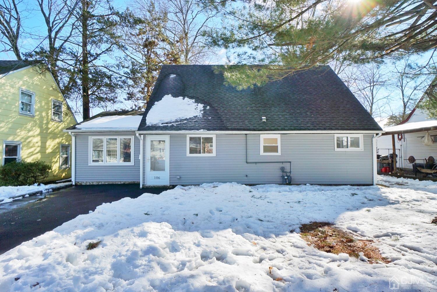 106 Ridge Road Colonia, NJ 07067 - Photo 1 of 44 a front view of a house with a yard covered in snow