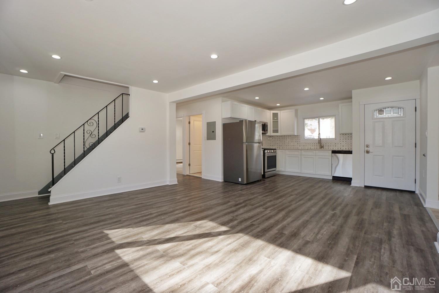 106 Ridge Road Colonia, NJ 07067 - Photo 13 of 44 a view of a big room with wooden floor and windows