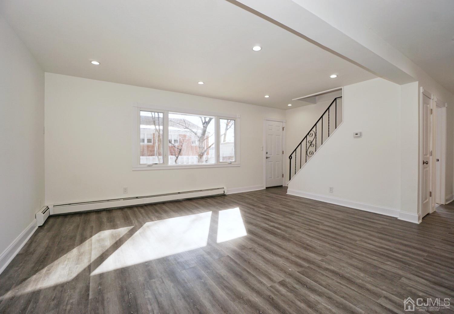 106 Ridge Road Colonia, NJ 07067 - Photo 15 of 44 a view of empty room with wooden floor and fan