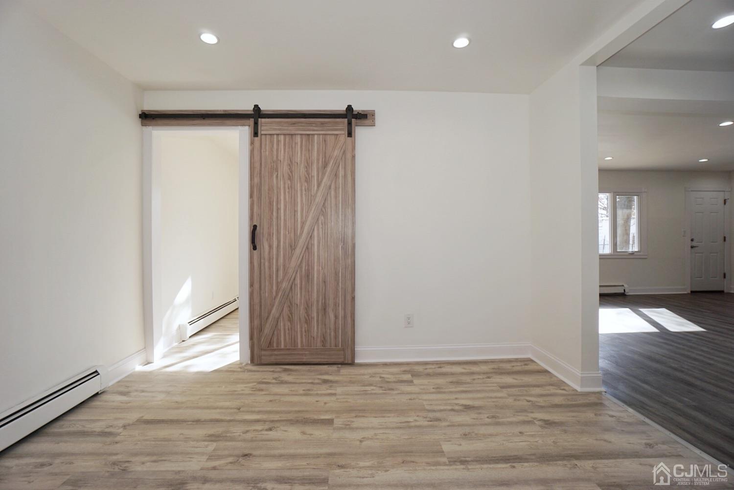 106 Ridge Road Colonia, NJ 07067 - Photo 18 of 44 a view of an empty room with wooden floor and a window