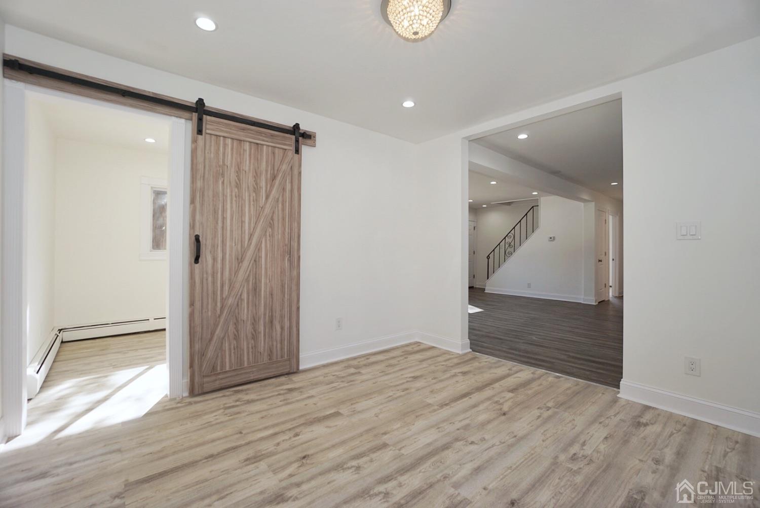 106 Ridge Road Colonia, NJ 07067 - Photo 20 of 44 wooden floor in an empty room with wooden floor and a bathroom