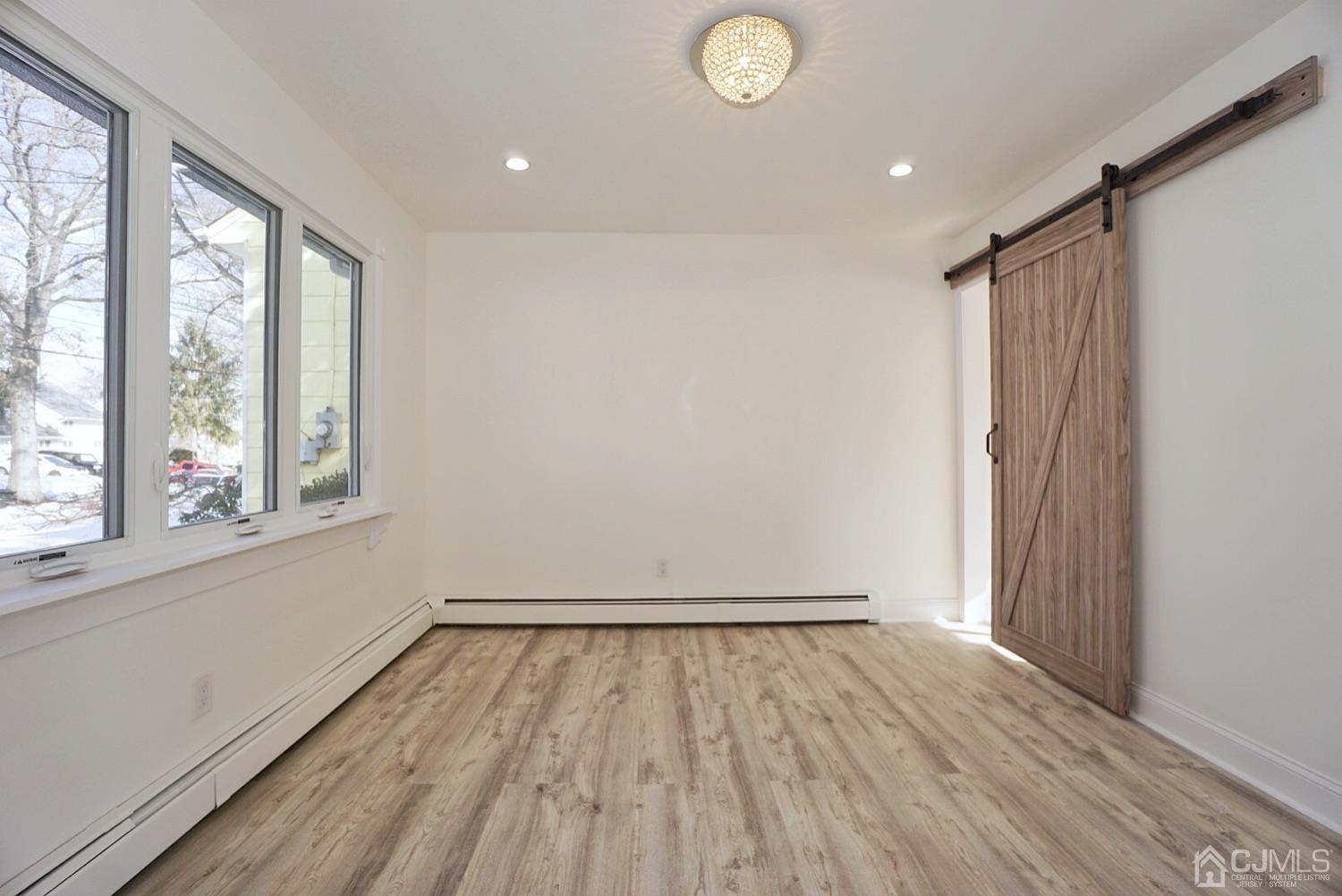 106 Ridge Road Colonia, NJ 07067 - Photo 22 of 44 a view of empty room with wooden floor and fan