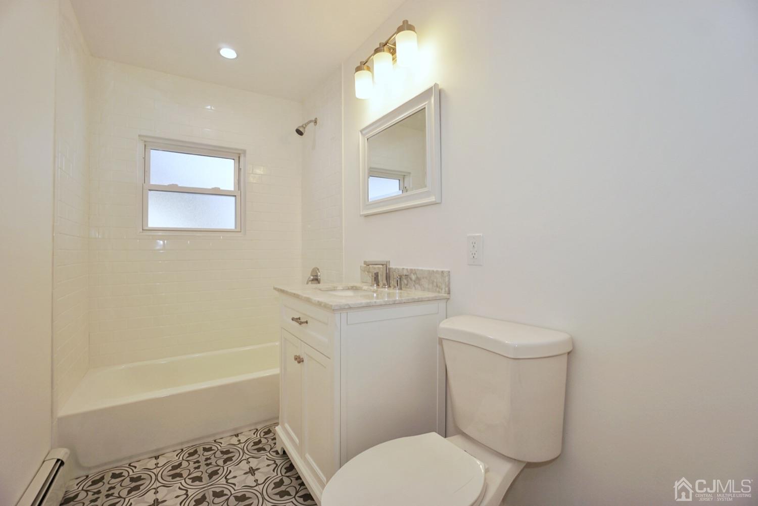 106 Ridge Road Colonia, NJ 07067 - Photo 23 of 44 a white toilet sitting next to a bath tub