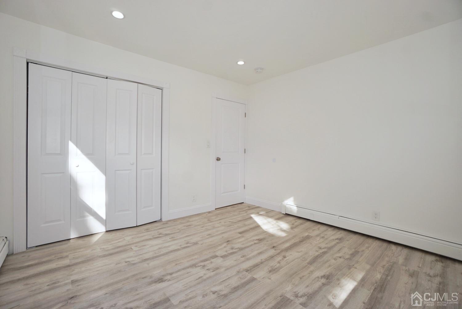 106 Ridge Road Colonia, NJ 07067 - Photo 27 of 44 a view of an empty room with wooden floor