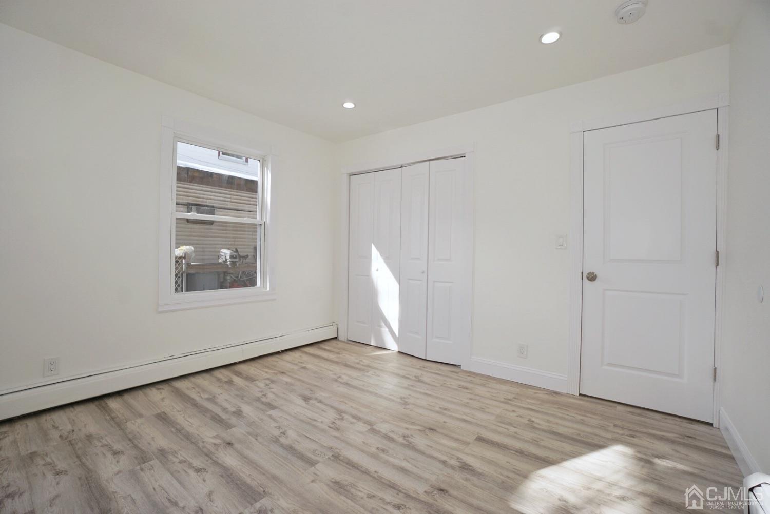106 Ridge Road Colonia, NJ 07067 - Photo 28 of 44 a view of an empty room with wooden floor and a window