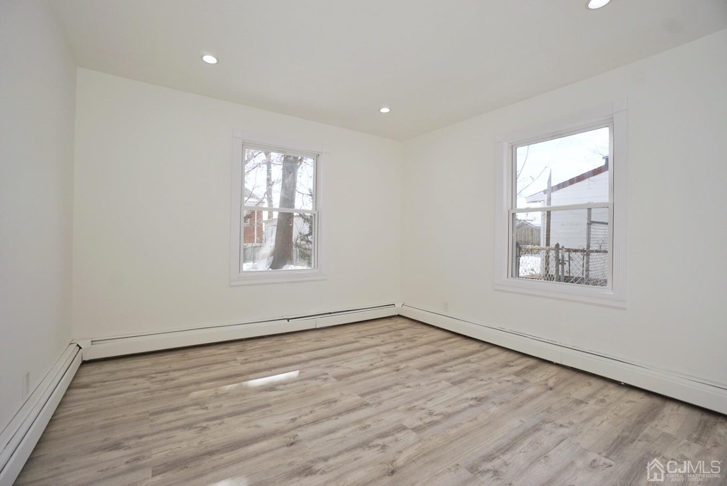 106 Ridge Road Colonia, NJ 07067 - Photo 29 of 44 wooden floor in an empty room with a window
