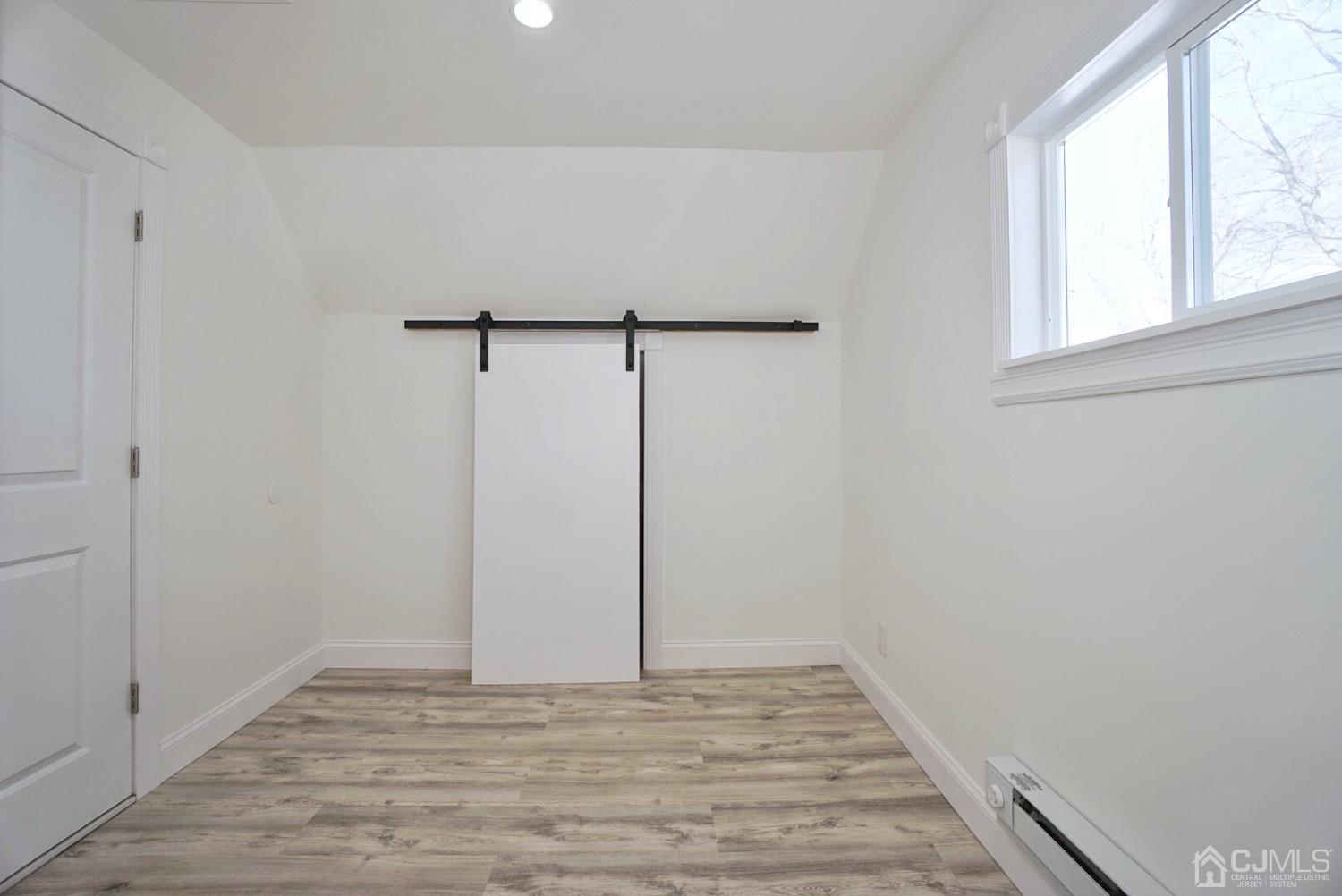 106 Ridge Road Colonia, NJ 07067 - Photo 30 of 44 a view of a room with wooden floor and window