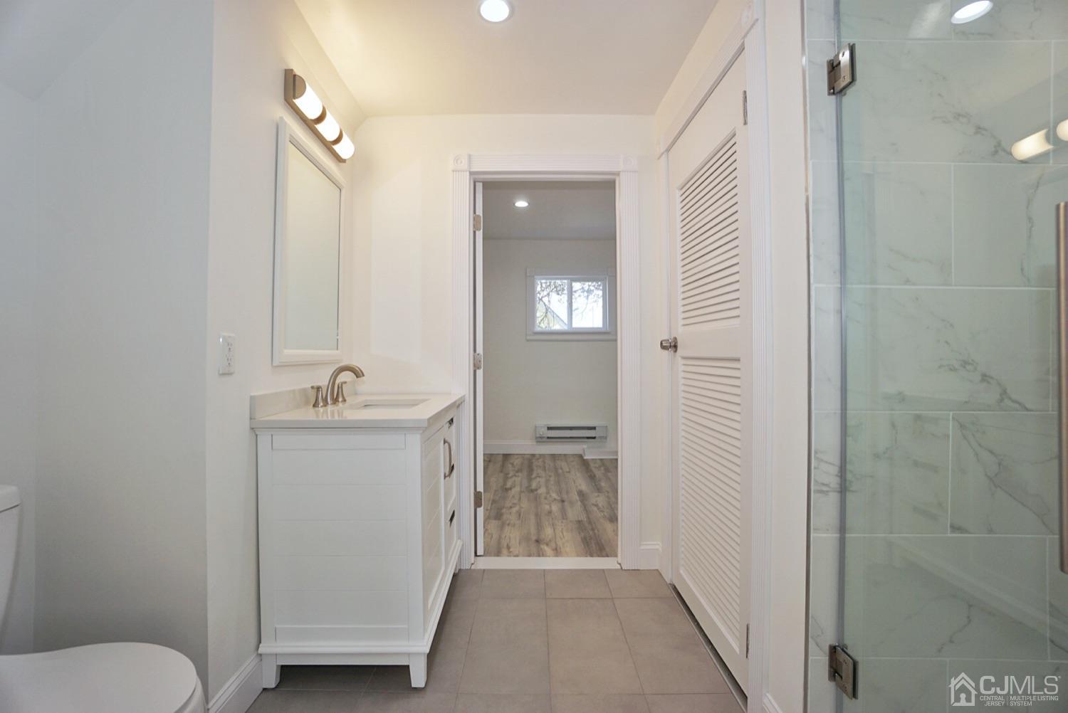 106 Ridge Road Colonia, NJ 07067 - Photo 37 of 44 a bathroom with a sink a toilet and shower
