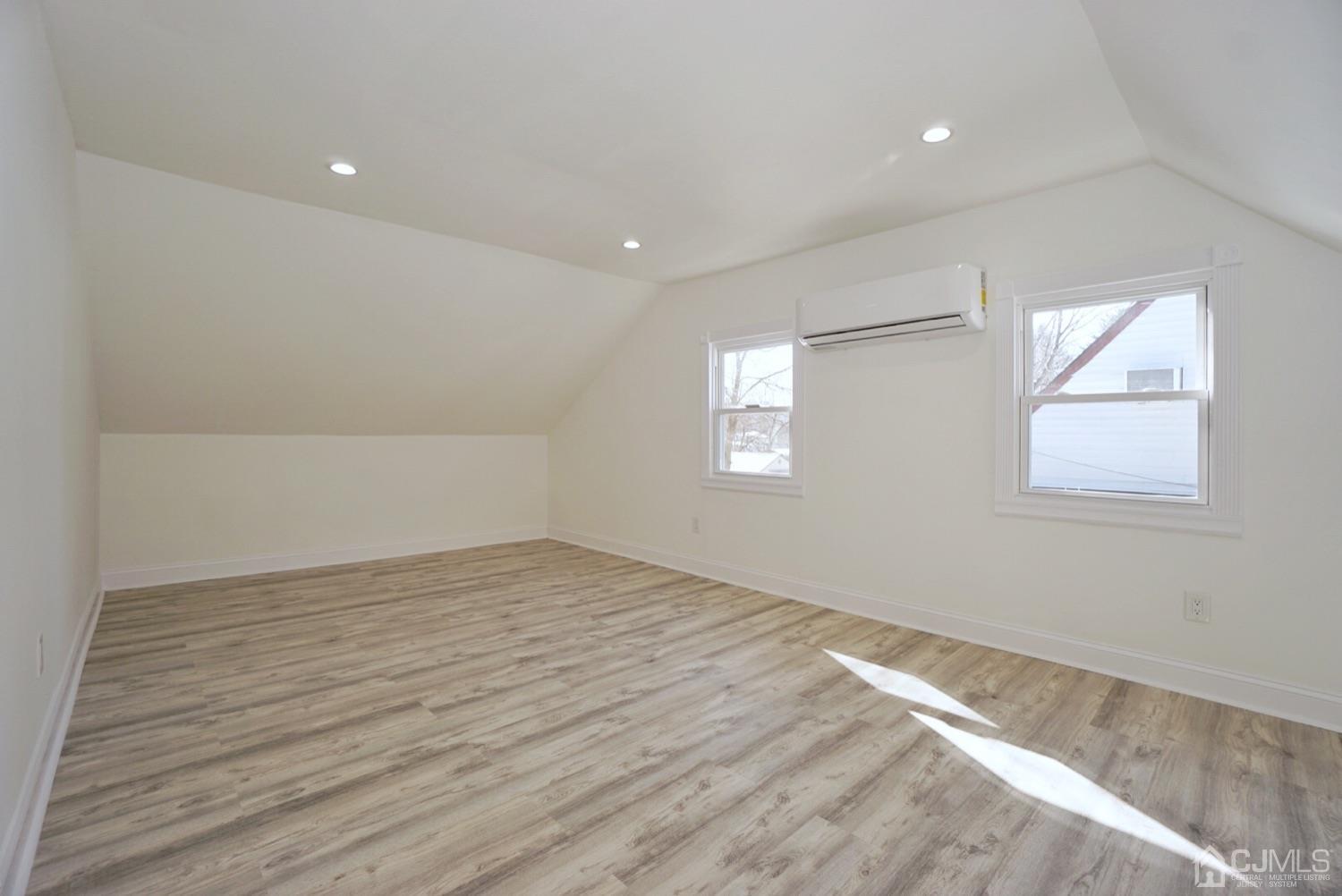 106 Ridge Road Colonia, NJ 07067 - Photo 38 of 44 an empty room with wooden floor and windows