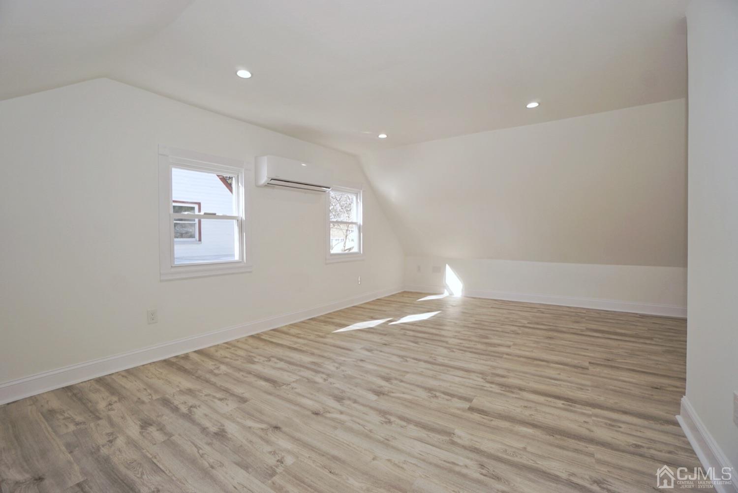 106 Ridge Road Colonia, NJ 07067 - Photo 42 of 44 a view of an empty room with wooden floor and a window