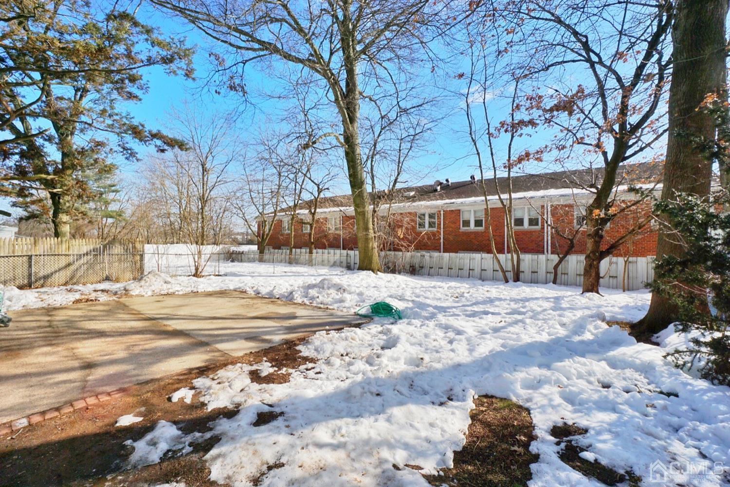 106 Ridge Road Colonia, NJ 07067 - Photo 44 of 44 a view of a white house with a yard covered in snow