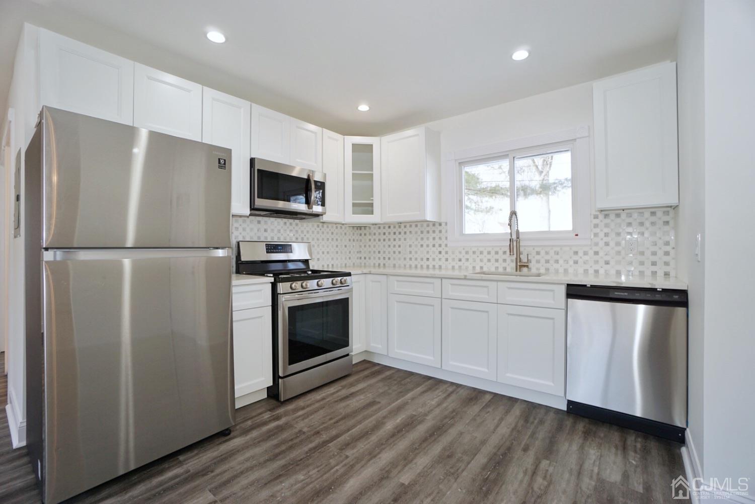 106 Ridge Road Colonia, NJ 07067 - Photo 9 of 44 a kitchen with stainless steel appliances granite countertop a refrigerator sink and microwave