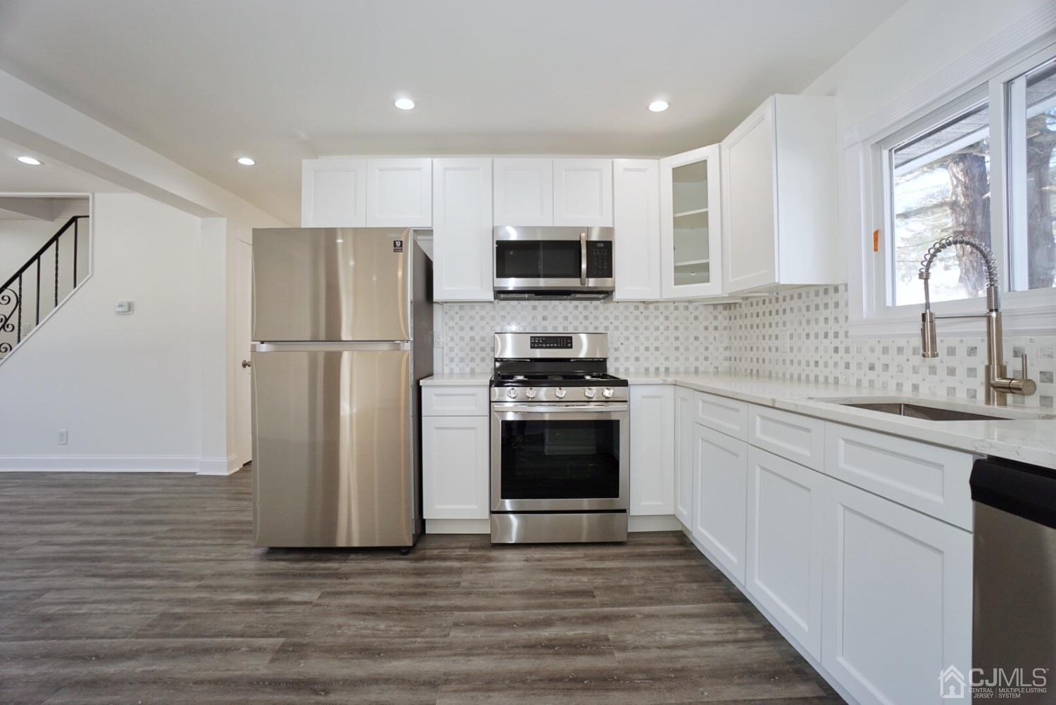 106 Ridge Road Colonia, NJ 07067 - Photo 10 of 44 a kitchen with a refrigerator and a sink
