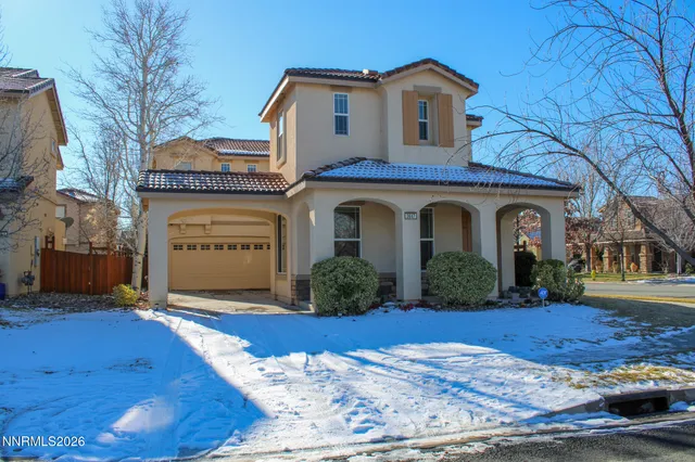 a living room with furniture a fireplace and a large window
