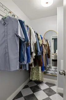 a view of walk in closet with clothes and shoes