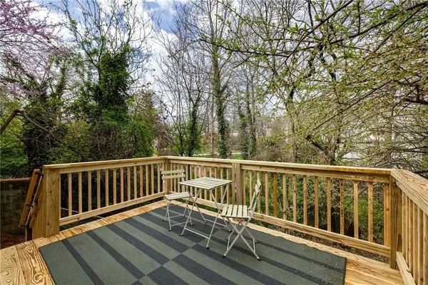 a view of balcony with wooden floor and fence