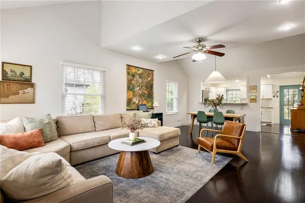 a living room with furniture ceiling fan and a window