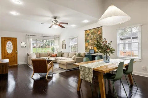 a living room with fireplace furniture and a large window