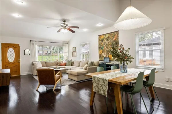 a living room with fireplace furniture and a large window