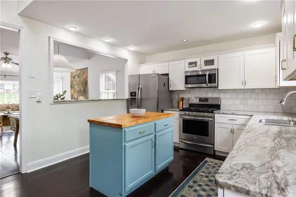 a kitchen with stainless steel appliances a stove sink and cabinets