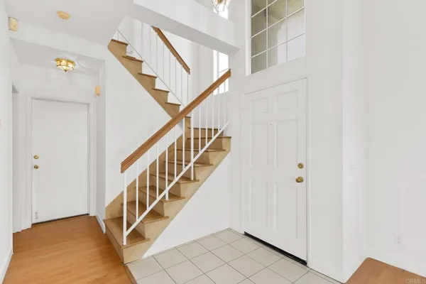 a view of a dining room with furniture and a chandelier