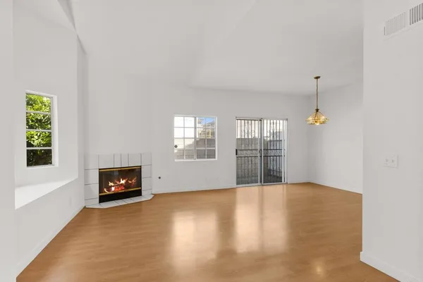 a view of a livingroom with wooden floor and stairs