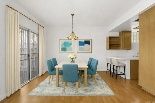 a view of a livingroom with wooden floor and a window
