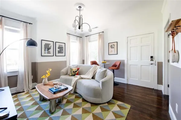 a living room with furniture and wooden floor