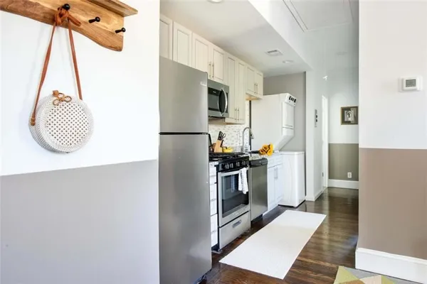 a kitchen with a refrigerator a stove and a microwave