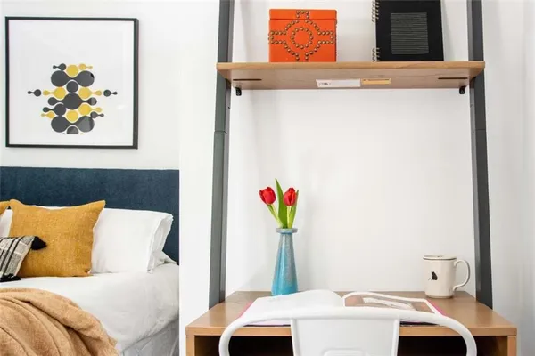 a bedroom with a bed and a window