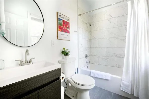 a bathroom with a sink a toilet and a mirror