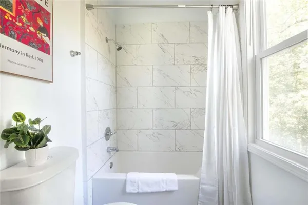 a bath tub sitting next to a white sink