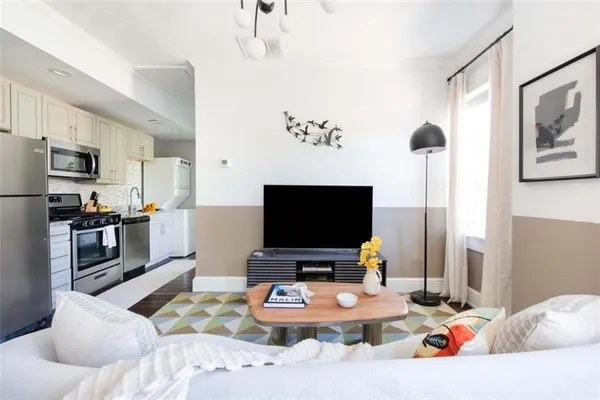 a living room with furniture and a flat screen tv