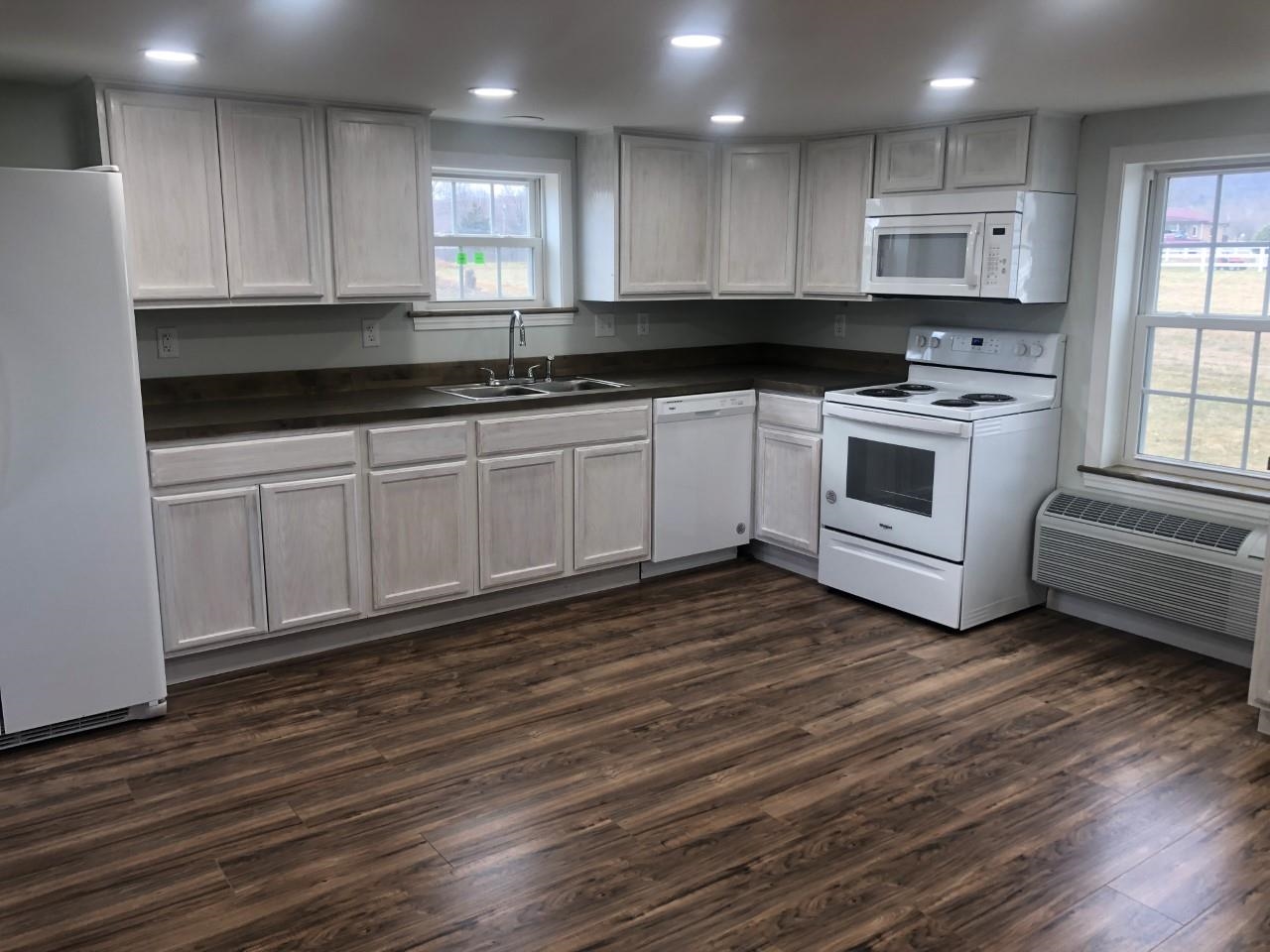 7057 Briery Branch Road Dayton, VA 22821 - Photo 15 of 29 a kitchen with granite countertop wooden cabinets and a stove