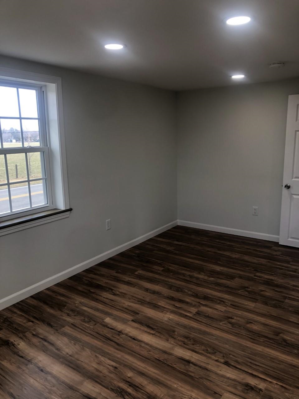 7057 Briery Branch Road Dayton, VA 22821 - Photo 24 of 29 an empty room with wooden floor and windows