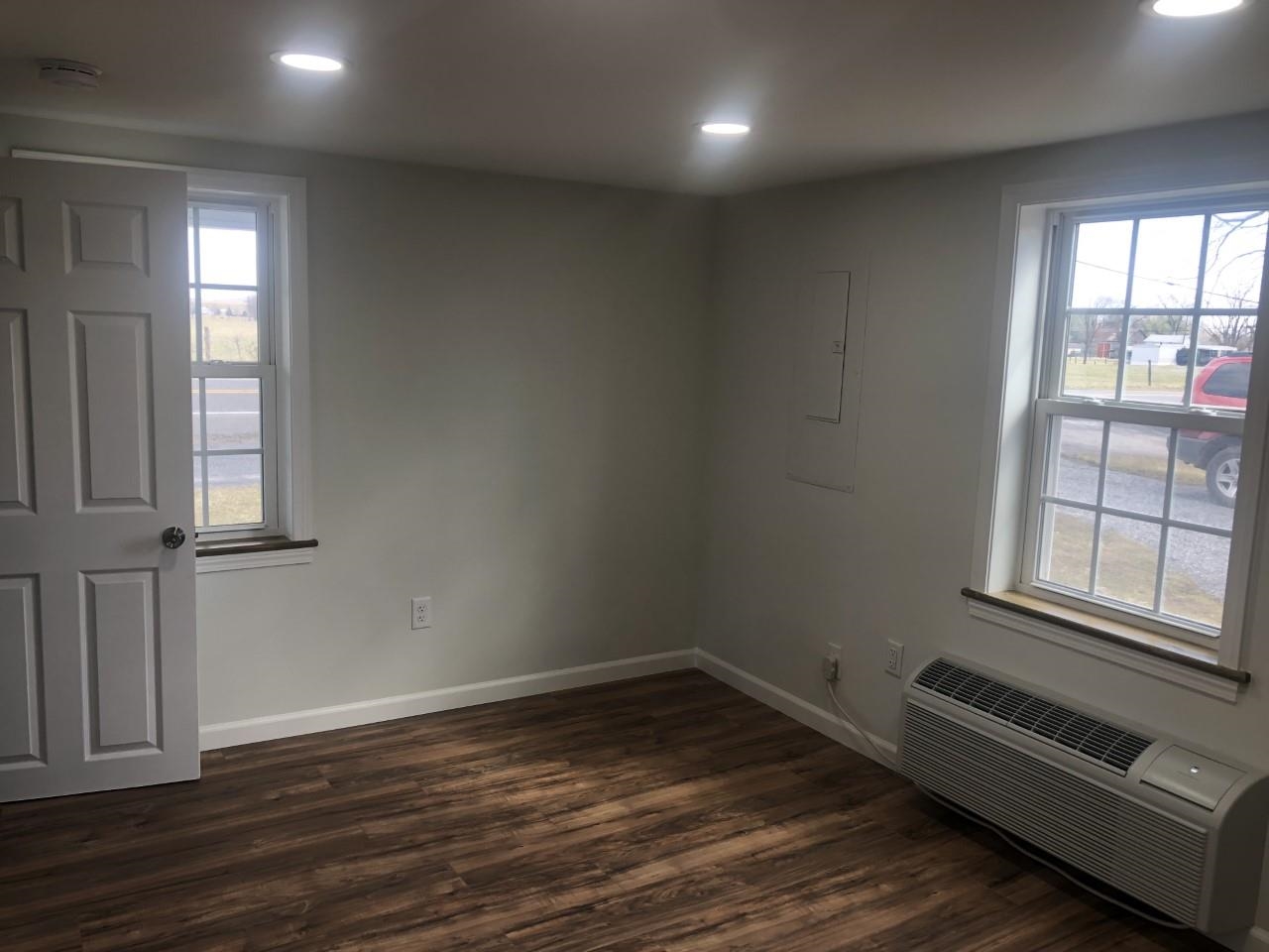 7057 Briery Branch Road Dayton, VA 22821 - Photo 9 of 29 an empty room with wooden floor and windows