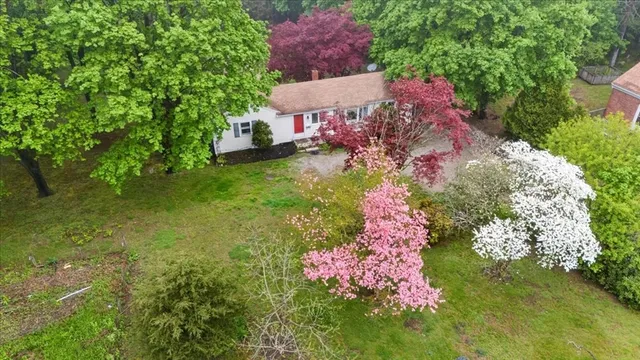 an aerial view of a house with swimming pool and garden