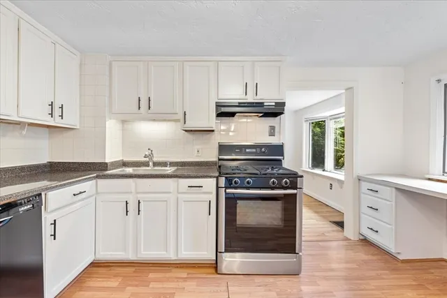 a kitchen with a stove oven and sink