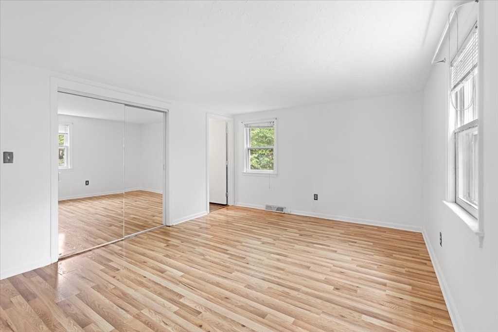 203 High Street, Unit 203 Hingham, MA 02043 - Photo 26 of 42 a view of empty room with wooden floor and fan
