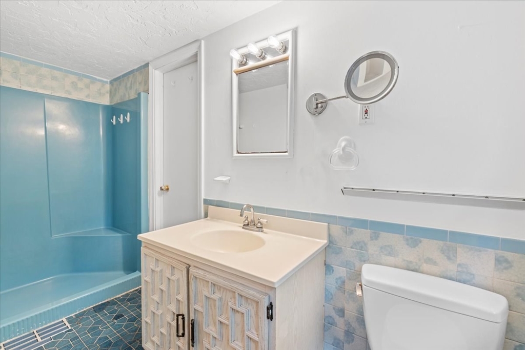 203 High Street, Unit 203 Hingham, MA 02043 - Photo 27 of 42 a bathroom with a sink a toilet and shower