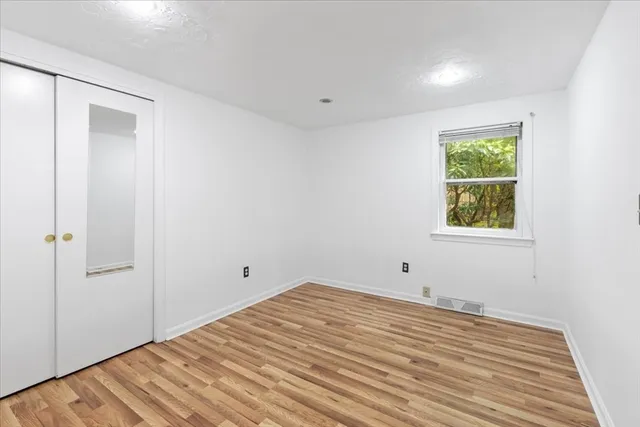 a view of a room with wooden floor and closet