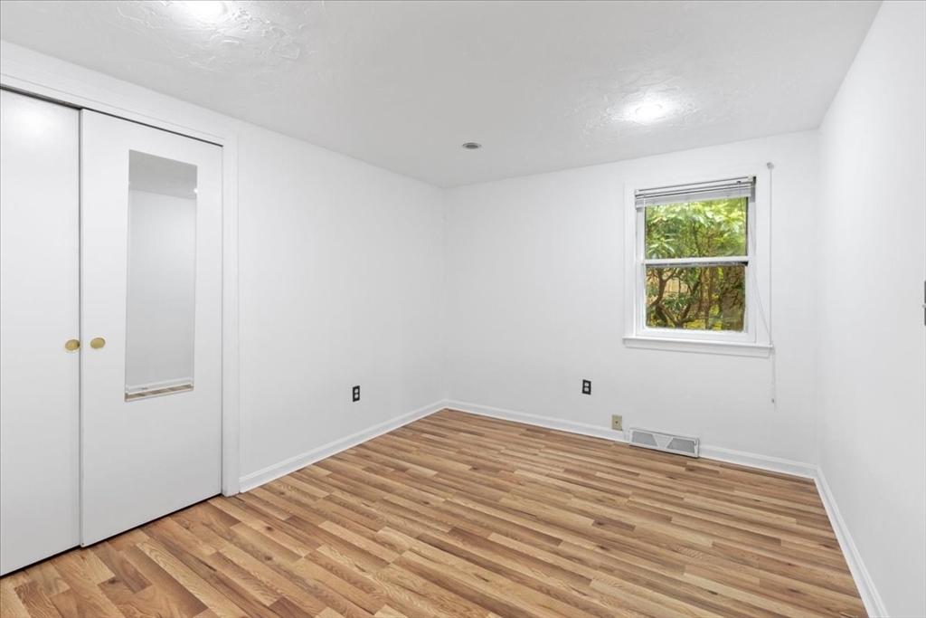 203 High Street, Unit 203 Hingham, MA 02043 - Photo 30 of 42 a view of empty room with wooden floor and fan