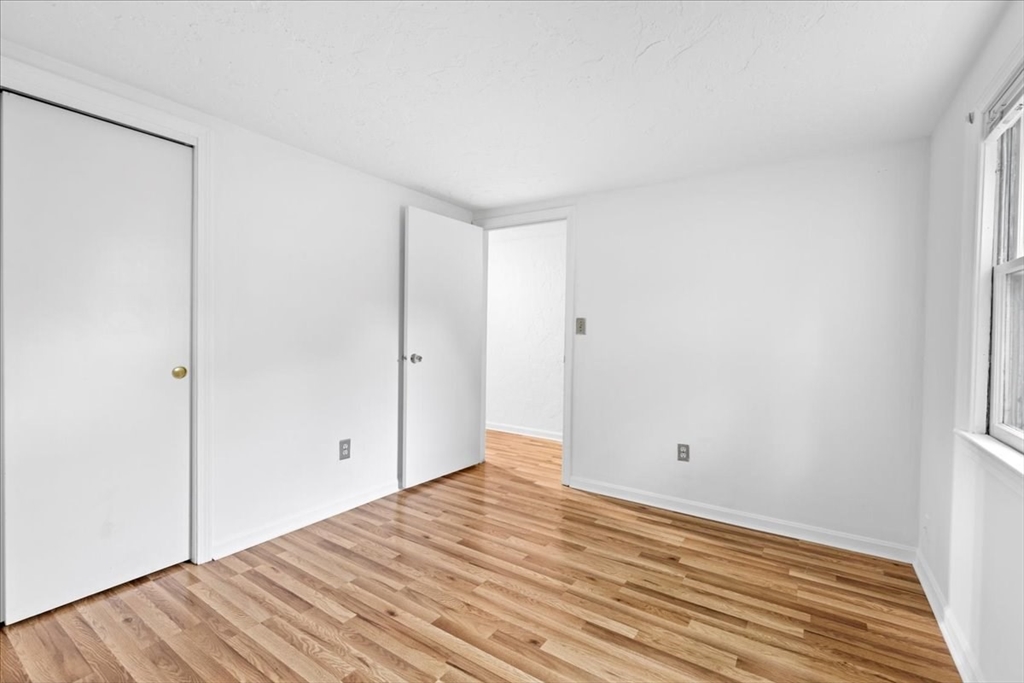 203 High Street, Unit 203 Hingham, MA 02043 - Photo 34 of 42 a view of empty room with wooden floor