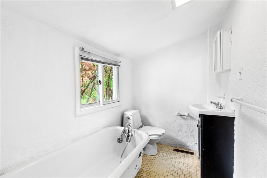 203 High Street, Unit 203 Hingham, MA 02043 - Photo 35 of 42 a bathroom with a bathtub sink and toilet