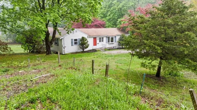 a view of a house with yard and a garden