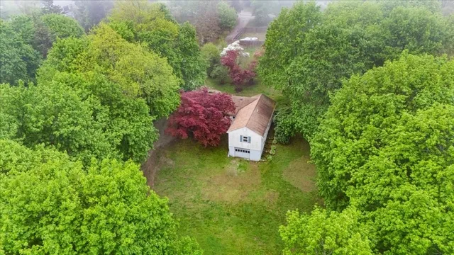 a aerial view of a house with a yard